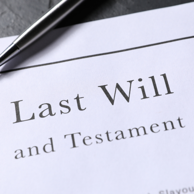 A close-up of a document titled Last Will and Testament with a silver pen resting on top.
