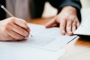 hand signing a legal paper