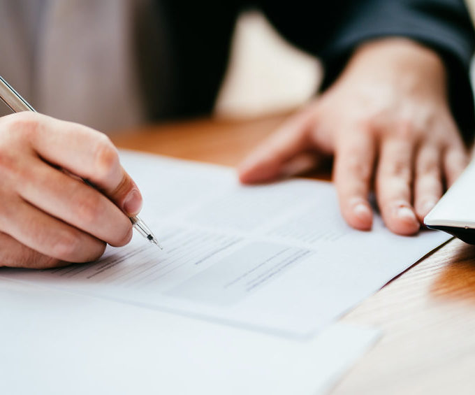 hand signing a legal paper