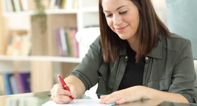 woman signing a deed