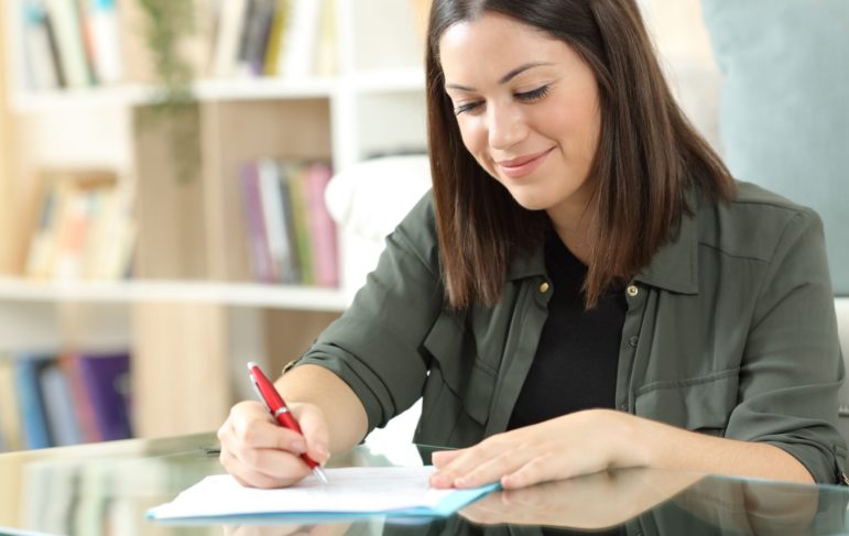 woman signing a deed