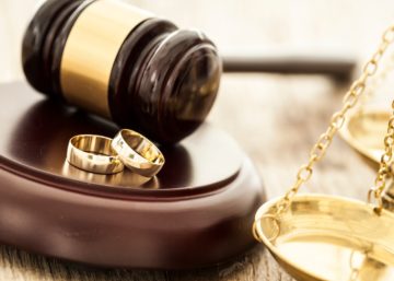 wedding rings and a gavel representing a prenuptial agreement