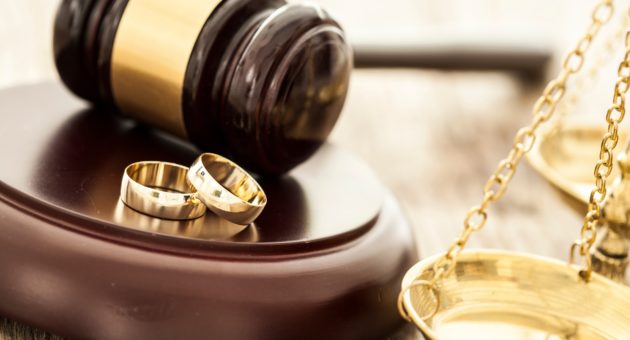 wedding rings and a gavel representing a prenuptial agreement