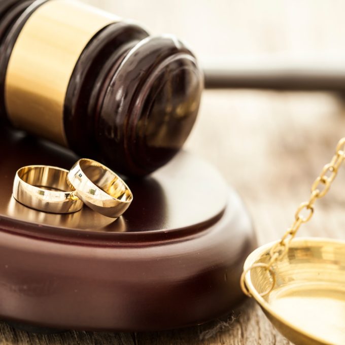 wedding rings and a gavel representing a prenuptial agreement