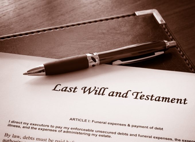 a will and a pen laying on a desk