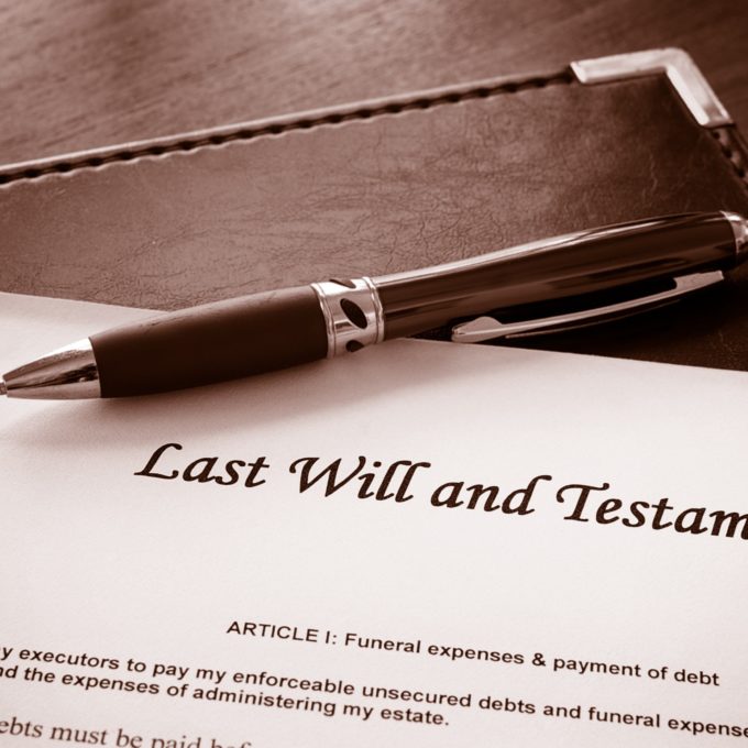 a will and a pen laying on a desk