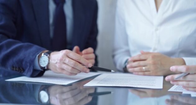 people talking over legal contracts