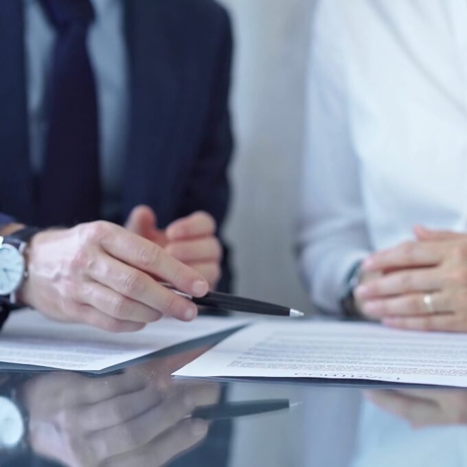 people talking over legal contracts