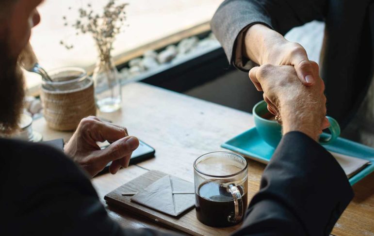 an attorney and client shaking hands